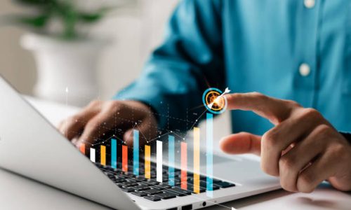Businessman analyzing company's financial balance sheet working with digital augmented reality graphics. Businessman calculates financial data for long-term investment.